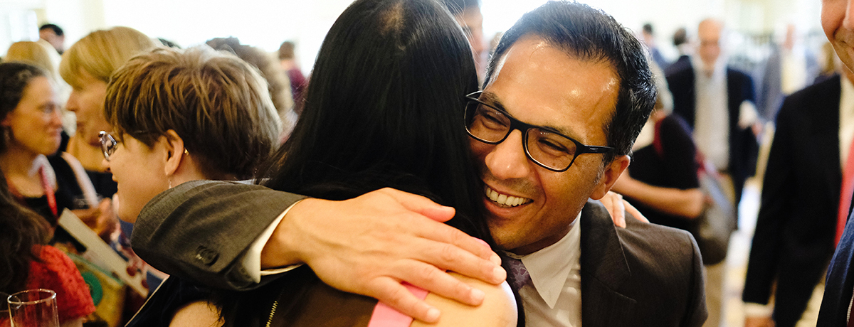 HMS alumnus hugging a n alumna during an event
